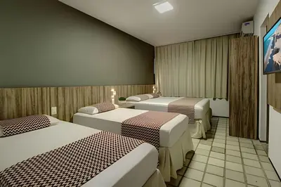 Uma cama ou camas num quarto em Mansão14Suítes-55Pessoas-BEACH PARK - HOUSINGCEARÁ