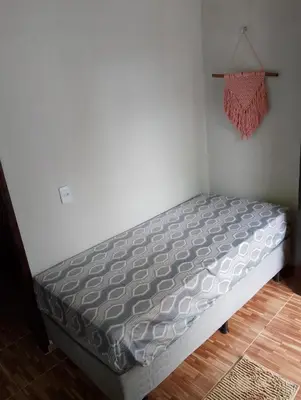 Uma cama ou camas num quarto em Pousada Casa São Carlos chalé Julyana