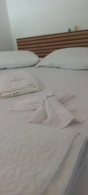 Uma cama ou camas num quarto em A Pousada Marcolino