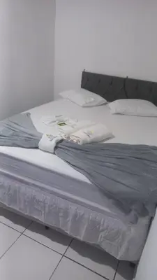 Uma cama ou camas num quarto em A Pousada Marcolino