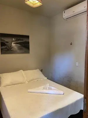 Uma cama ou camas num quarto em Casa de praia do pescador