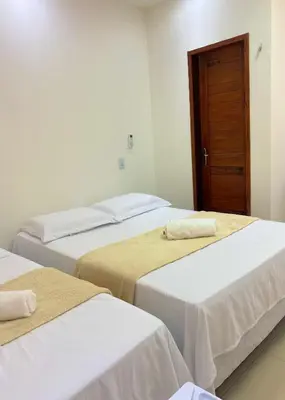 Uma cama ou camas num quarto em Suite no Centro da Praia de Flecheiras
