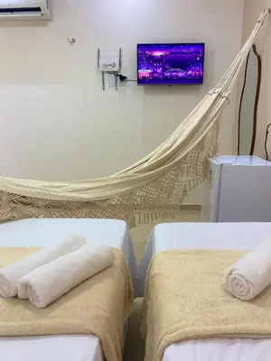 Uma cama ou camas num quarto em Suite no Centro da Praia de Flecheiras