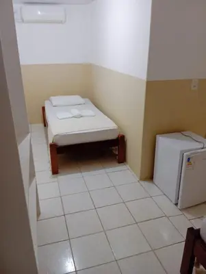 Uma cama ou camas num quarto em Pousada Sol do Centro