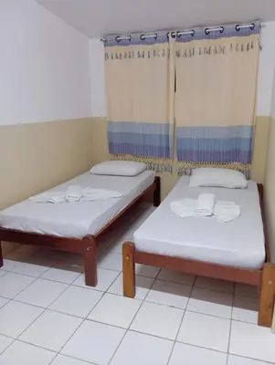 Uma cama ou camas num quarto em Pousada Sol do Centro