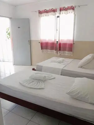 Uma cama ou camas num quarto em Pousada Sol do Centro