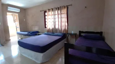 Uma cama ou camas num quarto em Pousada Virgínia