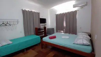 Uma cama ou camas num quarto em Pousada Virgínia