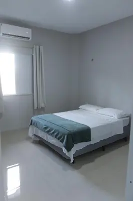 Uma cama ou camas num quarto em Suítes House Cacique