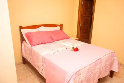 Uma cama ou camas num quarto em Casa de Hospedagem Cajueiro