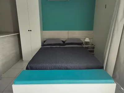 Uma cama ou camas num quarto em Residencial New Stilo-Falésia