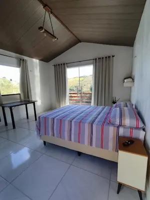 Uma cama ou camas num quarto em Chalé Bella Vista