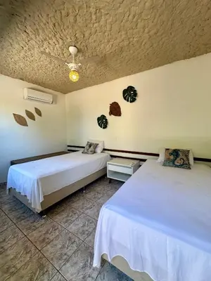 Uma cama ou camas num quarto em Pousada Villa do Sol Taiba
