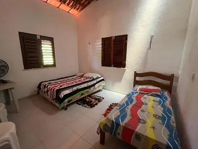 Uma cama ou camas num quarto em Casa de praia em Mundaú