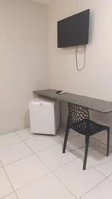 Uma televisão e/ou sistema de entretenimento em Pousada USE Sabor Caseiro