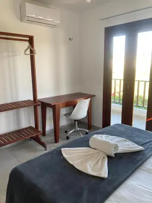 Uma cama ou camas num quarto em Casa Encanto dos Corais