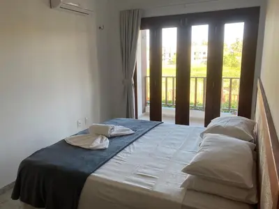 Uma cama ou camas num quarto em Casa Encanto dos Corais