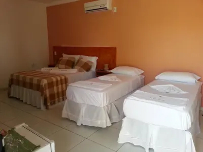 Uma cama ou camas num quarto em Pousada Brisa Do Pontal