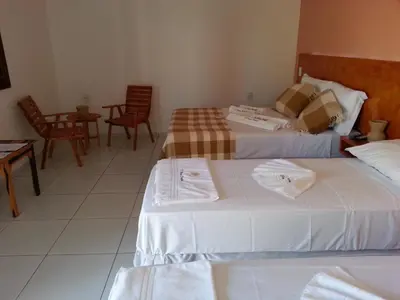 Uma cama ou camas num quarto em Pousada Brisa Do Pontal