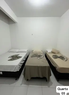 Uma cama ou camas num quarto em Casa Fundo de Quintal