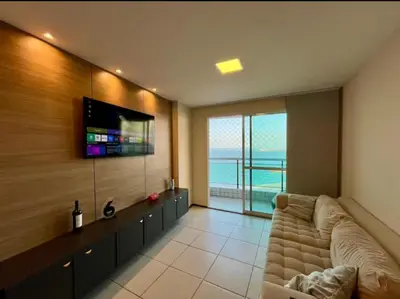 Uma televisão e/ou sistema de entretenimento em Terraço Atlântico Vista Mar 2 quartos 2 banheiros