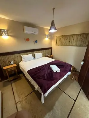 Uma cama ou camas num quarto em Pousada Caponga Praia Mar