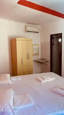 Uma cama ou camas num quarto em Pousada Rosa Mistica