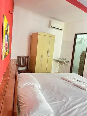 Uma cama ou camas num quarto em Pousada Rosa Mistica