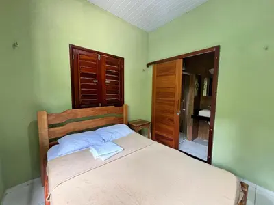 Uma cama ou camas num quarto em Casa em Guaramiranga há apenas 5 minutos das cachoeiras