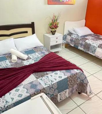 Uma cama ou camas num quarto em Pousada Novo Amanhecer