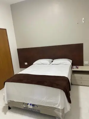 Uma cama ou camas num quarto em Hotel complexo paris