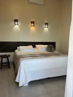 Uma cama ou camas num quarto em Vila Refúgio
