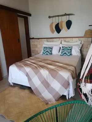 Uma cama ou camas num quarto em Vila Refúgio