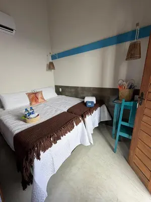 Uma cama ou camas num quarto em Pousada Villa Santorini Preá