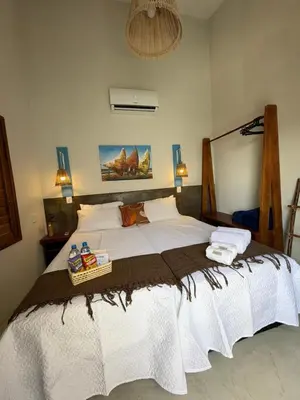 Uma cama ou camas num quarto em Pousada Villa Santorini Preá
