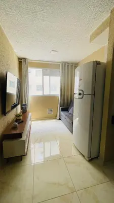Uma televisão e/ou sistema de entretenimento em Apartamento praia do futuro