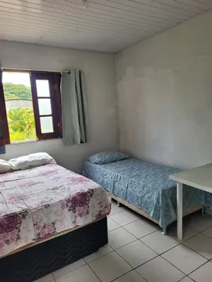 Uma cama ou camas num quarto em Sítio Guanabara