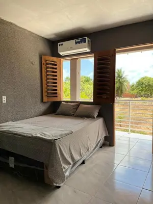 Uma cama ou camas num quarto em Pousada encantos de morro branco