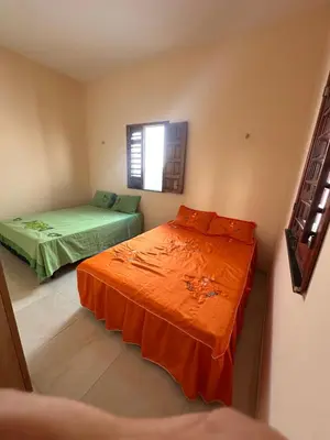 Uma cama ou camas num quarto em Casa Amarela no Fortim