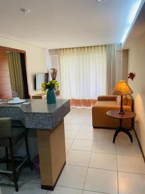 Uma área de estar em Apto Frente Piscina em Kariri Beach