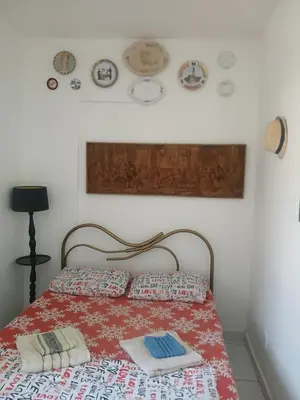 Uma cama ou camas num quarto em Quarto Aconchegante
