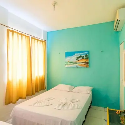 Uma cama ou camas num quarto em Pousada Maresia