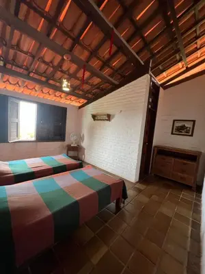 Uma cama ou camas num quarto em Casa incrível com vista para o mar - próximo ao beach park