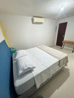 Uma cama ou camas num quarto em Casa no 1º piso com 2 Suítes a 200mts da praia
