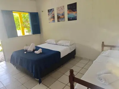 Uma cama ou camas num quarto em Casa Jambo Canoa Quebrada