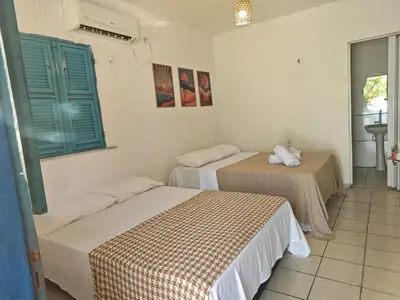 Uma cama ou camas num quarto em Casa Jambo Canoa Quebrada