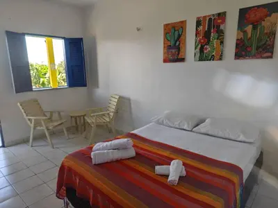Uma cama ou camas num quarto em Casa Jambo Canoa Quebrada