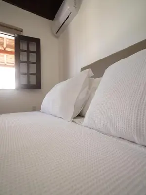 Uma cama ou camas num quarto em Beachfront Retreat with Pool and Garden