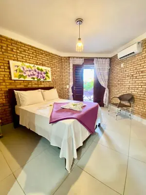 Uma cama ou camas num quarto em Pousada Casa Do Alemão