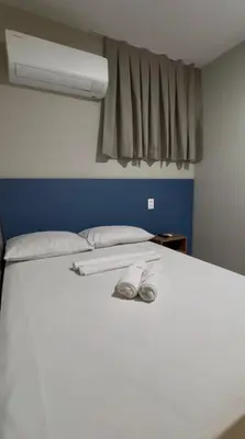 Uma cama ou camas num quarto em Pousada Meireles